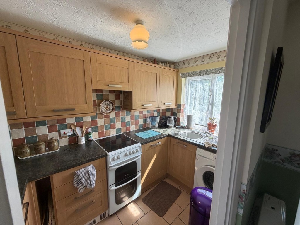 Lot: 131 - TWO-BEDROOM HOUSE FOR INVESTMENT OR OCCUPATION - Kitchen with brown cupboards and laminate work surfaces